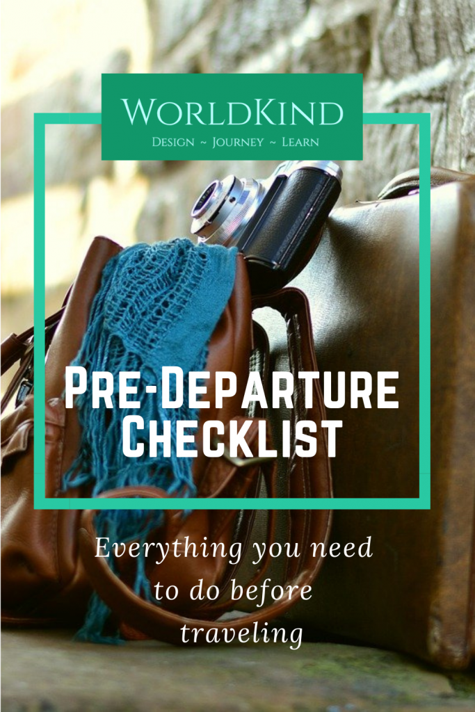 Pinterest image for Pre-Departure Checklist Blog post. Subtitle: Everything you need to do before you travel.  Luggage against a wall with a vintage-style camera and a scarf on top.