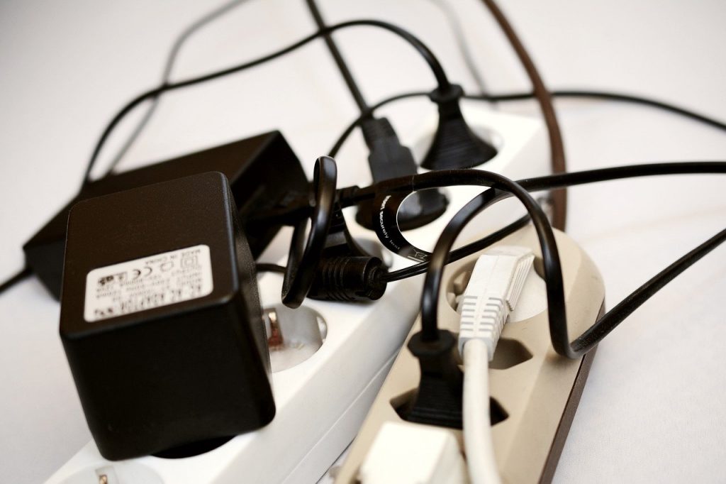 Image shows a tangle of cables plugged into two extension cords.